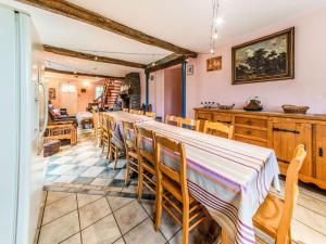 a dining room with a long table and chairs at Beautiful Farmhouse in Brisy with Sauna in Brisy