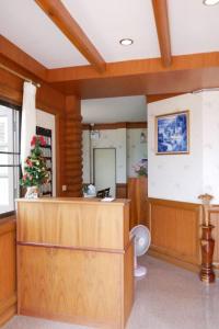a room with a reception desk and a christmas tree at TaLeKaew Resort SHA in Phitsanulok