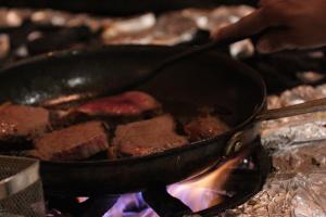a pan of food cooking on a stove at Hotel Casa Quero in Cartagena de Indias