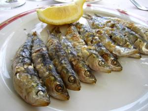 a plate of fish with a slice of lemon at La Baraka de Guadalmar B&B Aeropuerto in Málaga