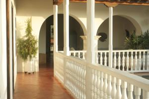 a large white house with a balcony and a balcony view at Hotel Casa Quero in Cartagena de Indias