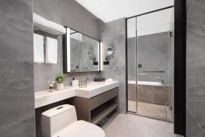 a bathroom with a toilet and a sink and a shower at Somerset Daxing Beijing in Daxing