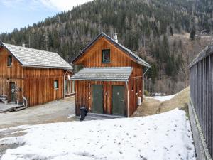 a large wooden barn with snow on the ground at Holiday home in Styria with balcony in Stadl an der Mur