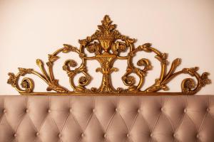 a gold crown on top of a couch at ARCHONTARIKI Historic Boutique Hotel in Ioannina