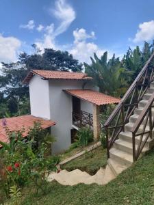 a house with stairs leading up to it at CASINHA DA SERRA in Baturité