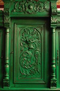 a green wooden door with a carving on it at ARCHONTARIKI Historic Boutique Hotel in Ioannina
