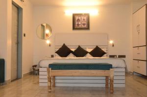 a bedroom with a large bed and a mirror at Divy Villa in Jaipur