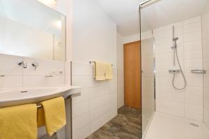 a bathroom with a sink and a shower at Appartements Künk in Schruns-Tschagguns