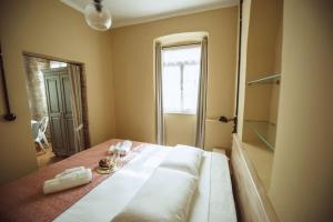 a bedroom with a large bed with a mirror at Calista Liston Corfu Apartment in Corfu Town