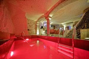 a hot tub with red lighting in a room at Love Bells Cappadocia in Nevsehir