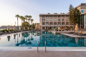 a large swimming pool in front of a hotel at Fame Residence Kemer & Spa in Kemer