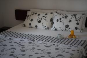 a bed with black and white sheets and pillows at Spa Resort Luxury Apartments in Budva