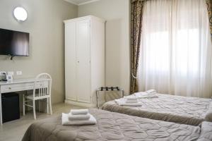 Łóżko lub łóżka w pokoju w obiekcie Hotel Domus