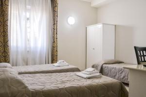 Łóżko lub łóżka w pokoju w obiekcie Hotel Domus