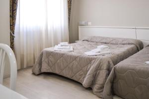 Łóżko lub łóżka w pokoju w obiekcie Hotel Domus