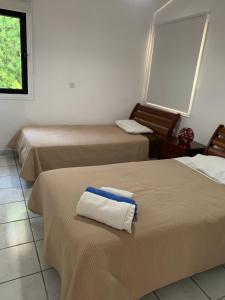 a room with three beds with towels on them at Villa Anna Maria in Coral Bay +114 photos