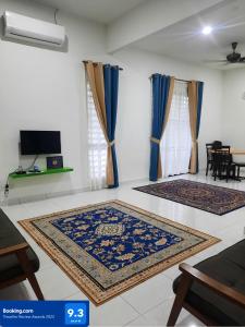 a living room with two rugs on the floor at AZ Homestay Bertam Perdana With Free Wifi in Kepala Batas