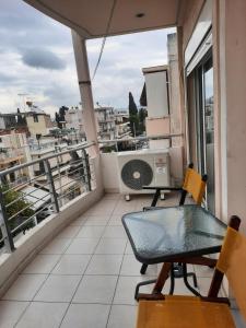 a balcony with a table and a fan at One bedroom apartment new with large living room in Athens