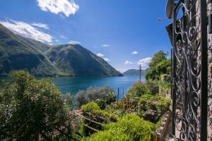 a view of a lake from a house at Magic Gandria - Happy Rentals in Lugano