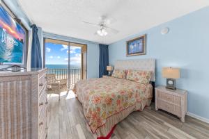 a bedroom with a bed and a balcony with the ocean at Romar Place 401 Gulf-Front w Pool in Orange Beach