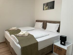 two beds in a room with a tv on a table at E&B Apartments Korb in Korb