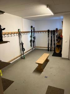 a room with skis on the wall and a bench at Spacious apartment up to 6 people in Flims in Flims