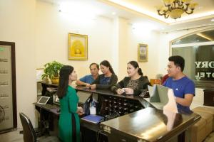 a group of people standing around a bar in a room at Victory Hotel, số 7, Vương Thúc Mậu, Tp Vinh in Vinh