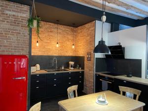 een keuken met een houten tafel en een rode koelkast bij The Loft, by So & Dam’s in Thonon-les-Bains