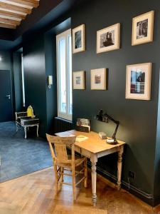 a room with a wooden desk with a lamp on it at The Loft, by So & Dam’s in Thonon-les-Bains