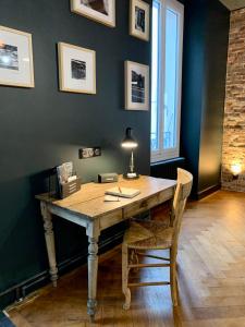 una mesa de madera con una lámpara y una silla en una habitación en The Loft, by So & Dam’s, en Thonon-les-Bains
