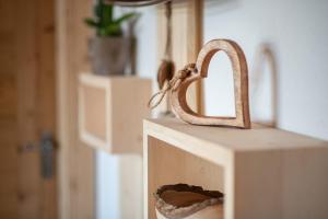 a wooden house with a snake sticking out of it at Oberglarzhof App Kirsch in Villnoss +7 photos