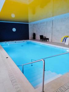 a large swimming pool in a room with at Domitys Les Raisins Bleus in Villiers-sur-Marne