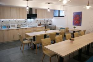 a restaurant with tables and chairs and a kitchen at CASA SMIDA ACTIV in Smida +12 photos