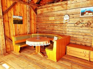 a room with a table and a bench in a cabin at Large detached holiday home in Muhr in Muhr