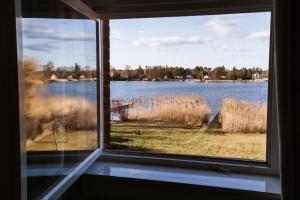 a window view of a lake from a house at Ferienwohnung an der Berliner Seenkette in Schwerin