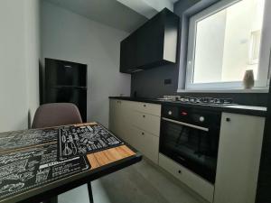 a kitchen with a table and a stove top oven at Dolphin Apartment near Neversea Beach in Constanţa