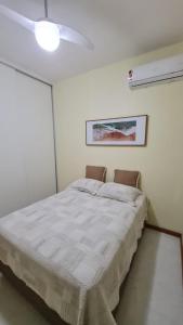 a bed in a white room with a ceiling fan at Copacabana Front beach 2 in Rio de Janeiro +13 photos