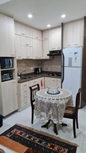 a kitchen with a table and chairs and a white refrigerator at Copacabana Front beach 2 in Rio de Janeiro +13 photos