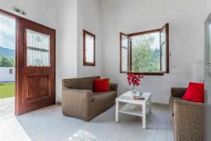 a living room with two chairs and a table at Ageri Studios in Stafylos