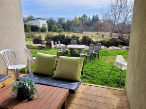 a patio with a table and chairs and a field at Holiday home in Galilee in Sheʼar Yashuv