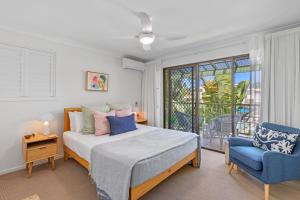 a bedroom with a bed and a chair and a window at Noosa Village River Resort in Noosaville +121 photos