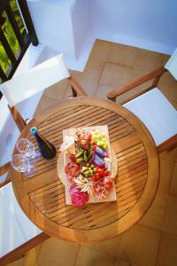 a plate of food sitting on a wooden table at Casa Eneida frente al mar in Tías