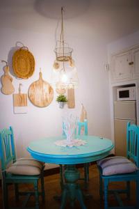 a blue table with two chairs and a light fixture at Casa Eneida frente al mar in Tías