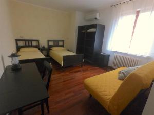 een woonkamer met 2 bedden en een tafel bij Pedalare con lentezza in Porto SantʼElpidio