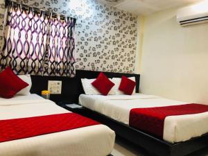 Postel nebo postele na pokoji v ubytování Hotel Guestinn Residency