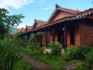 a brick house with a pathway in front of it at Ndalem Setumbu in Magelang
