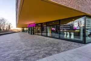 a store front of a building with a lot of windows at Prize by Radisson, Bonn City in Bonn