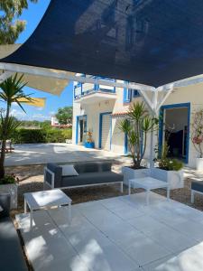 un patio con sofás y mesas frente a una casa en B&B Campitur, en Campomarino