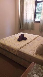 a pair of beds in a bedroom with a hat on it at Cool Living at GVR Landed Unit in Genting Highlands