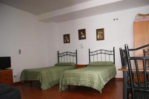 Postel nebo postele na pokoji v ubytování Hostal Alcázar